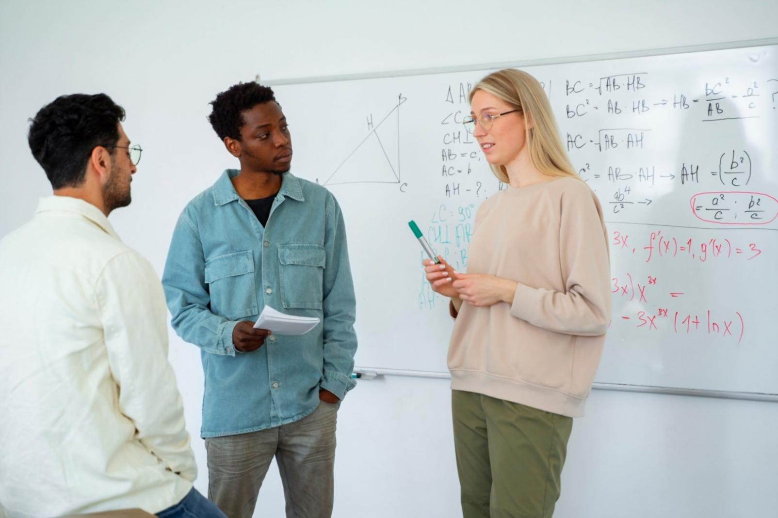 Financial analyst working with complex spreadsheet models on multiple monitors